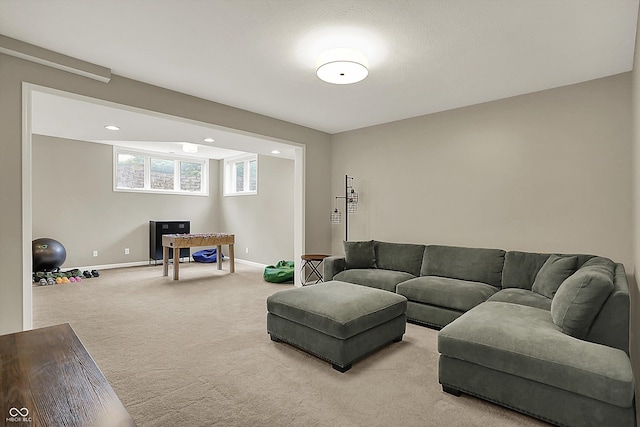 living room with baseboards, light carpet, and recessed lighting