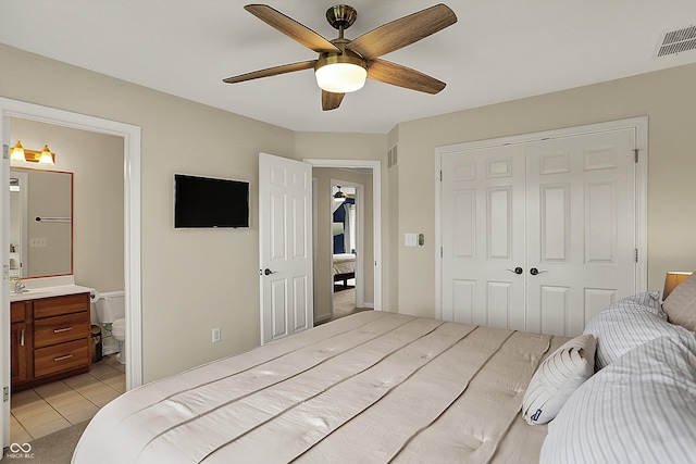 bedroom featuring visible vents, ceiling fan, light tile patterned floors, and a closet