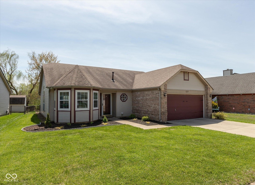 single story home with driveway, roof with shingles, a front yard, a garage, and brick siding