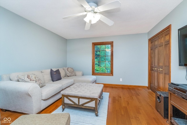 4401 W Hunters Ridge Ln W, Greenwood, IN 46143 - living room featuring baseboards, a ceiling fan, and light wood-type flooring