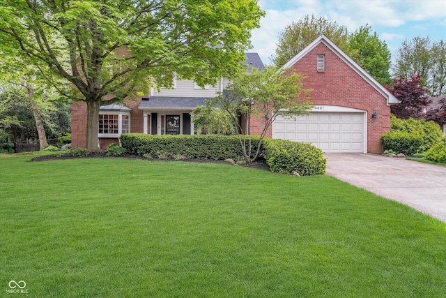 4401 W Hunters Ridge Ln W, Greenwood, IN 46143 - view of front facade with brick siding, an attached garage, driveway, and a front yard