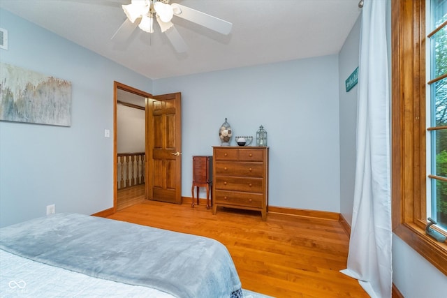 4401 W Hunters Ridge Ln W, Greenwood, IN 46143 - bedroom featuring ceiling fan, baseboards, visible vents, and wood finished floors