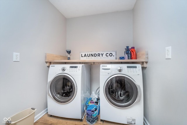 4401 W Hunters Ridge Ln W, Greenwood, IN 46143 - laundry area with separate washer and dryer, laundry area, baseboards, and light wood-style flooring
