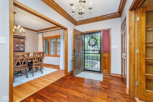 4401 W Hunters Ridge Ln W, Greenwood, IN 46143 - foyer with crown molding, baseboards, wood finished floors, and a notable chandelier