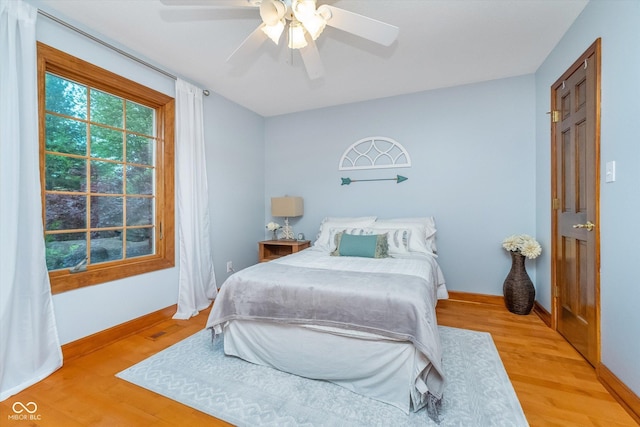 4401 W Hunters Ridge Ln W, Greenwood, IN 46143 - bedroom with baseboards, ceiling fan, and light wood-style flooring