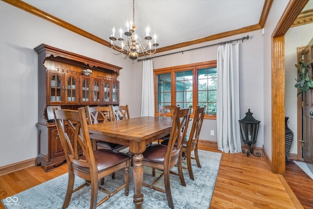 4401 W Hunters Ridge Ln W, Greenwood, IN 46143 - dining room featuring baseboards, a chandelier, ornamental molding, and light wood-type flooring