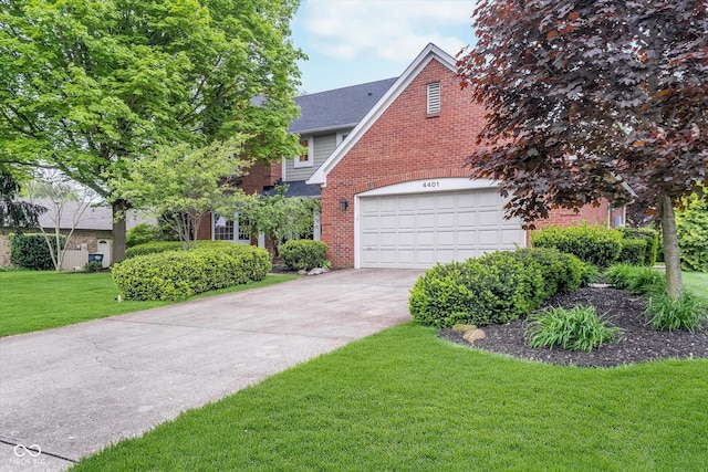 4401 W Hunters Ridge Ln W, Greenwood, IN 46143 - view of front of home with brick siding, a front lawn, an attached garage, and driveway