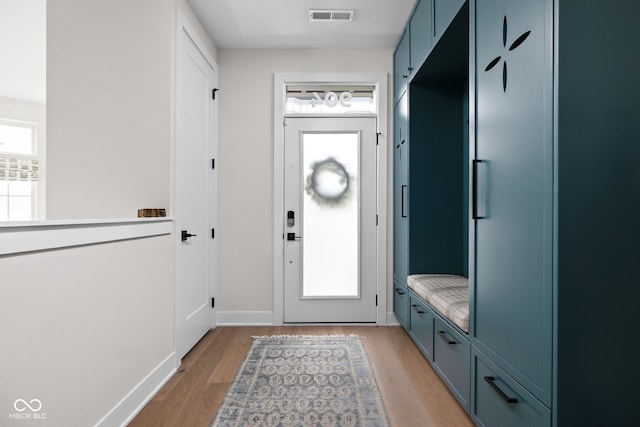 mudroom with baseboards, visible vents, and light wood-style flooring