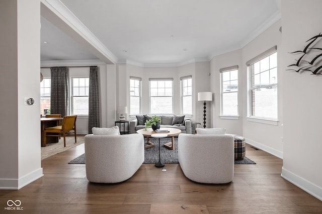 living room featuring crown molding, baseboards, plenty of natural light, and dark wood finished floors