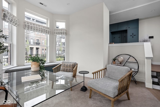 sitting room with baseboards and visible vents