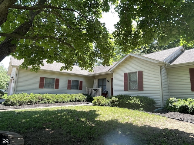 4611 29th St, Columbus, IN 47203 - ranch-style home featuring a front yard and a shingled roof