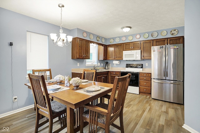 11620 E 75th St, Indianapolis, IN 46236 - dining space with light wood-type flooring, a chandelier, baseboards, and a textured ceiling