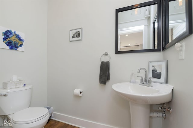 825 Iowa St, Indianapolis, IN 46203 - half bathroom with wood finished floors, baseboards, and toilet