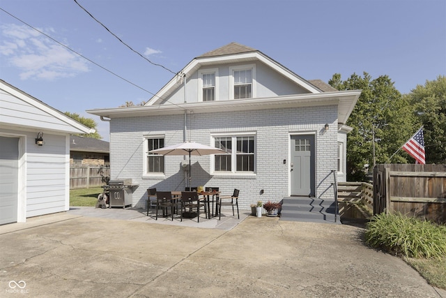 825 Iowa St, Indianapolis, IN 46203 - rear view of house featuring brick siding, a patio area, fence, and entry steps