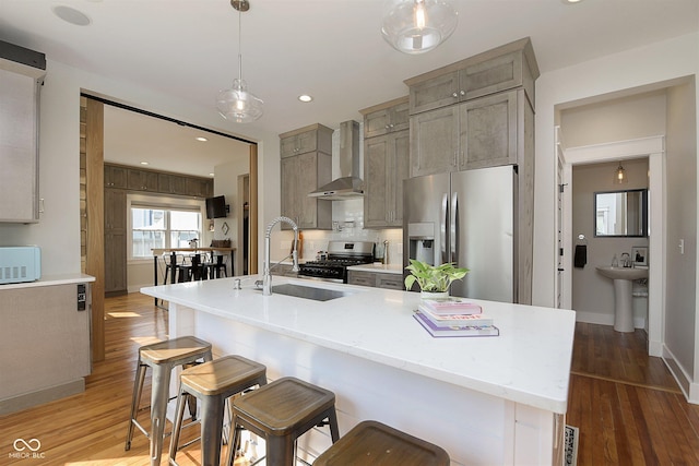 825 Iowa St, Indianapolis, IN 46203 - kitchen with a sink, stainless steel appliances, wall chimney range hood, and wood finished floors
