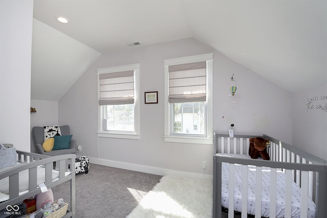 825 Iowa St, Indianapolis, IN 46203 - bedroom featuring carpet flooring, a crib, visible vents, baseboards, and lofted ceiling