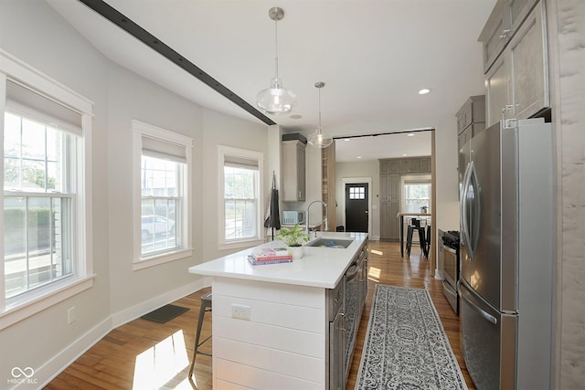 825 Iowa St, Indianapolis, IN 46203 - kitchen featuring a breakfast bar, dark wood finished floors, appliances with stainless steel finishes, and a sink