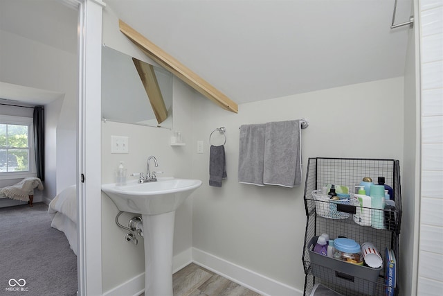 825 Iowa St, Indianapolis, IN 46203 - bathroom with a sink, lofted ceiling with beams, and baseboards