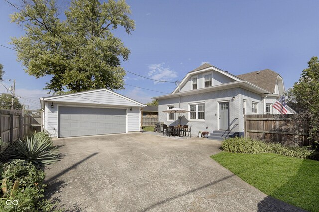 825 Iowa St, Indianapolis, IN 46203 - view of front of property featuring an outdoor structure, fence, a garage, entry steps, and a front lawn