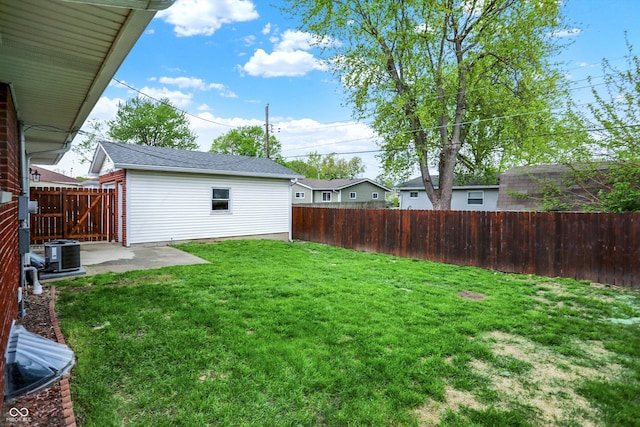 view of yard with a fenced backyard, a patio, and central AC unit
