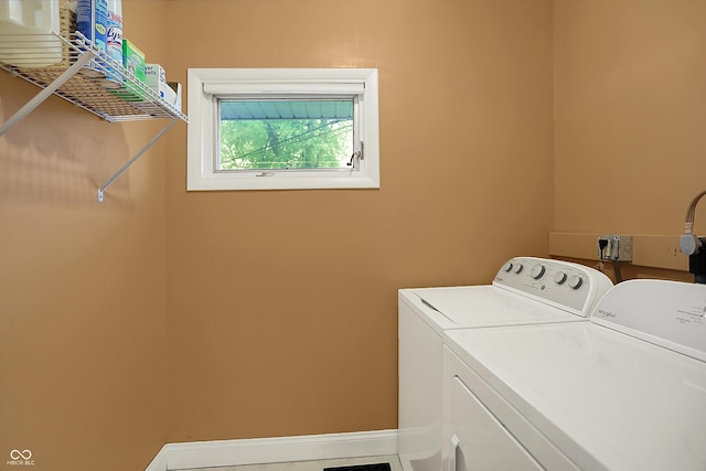 laundry area featuring baseboards, laundry area, and washer and clothes dryer
