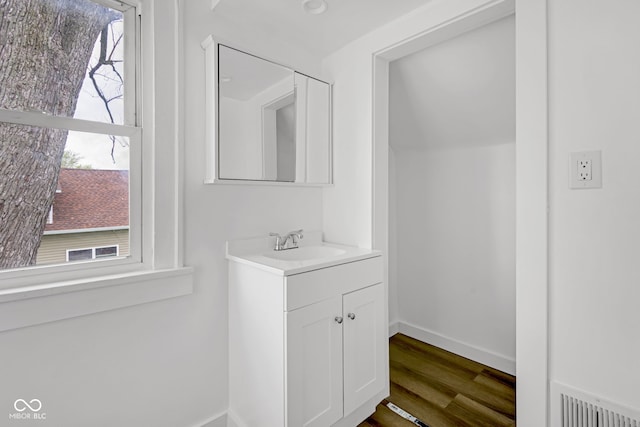 555 S Auburn St, Indianapolis, IN 46241 - bathroom featuring baseboards, vanity, wood finished floors, and visible vents