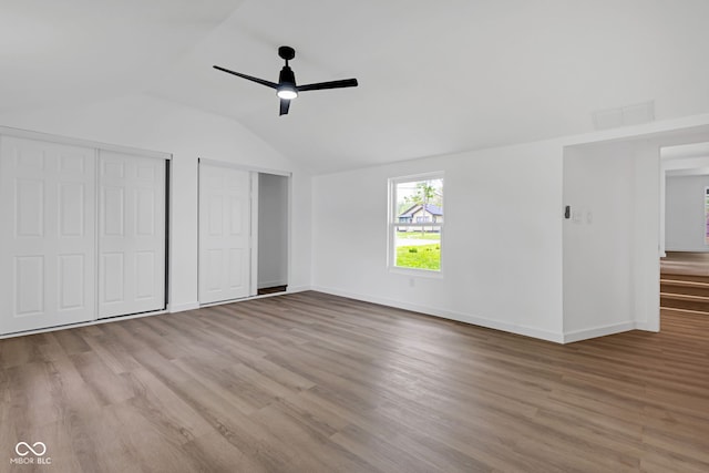 555 S Auburn St, Indianapolis, IN 46241 - unfurnished bedroom featuring multiple closets, vaulted ceiling, wood finished floors, and visible vents