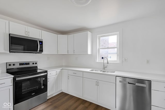 555 S Auburn St, Indianapolis, IN 46241 - kitchen with a sink, stainless steel appliances, dark wood finished floors, and white cabinetry