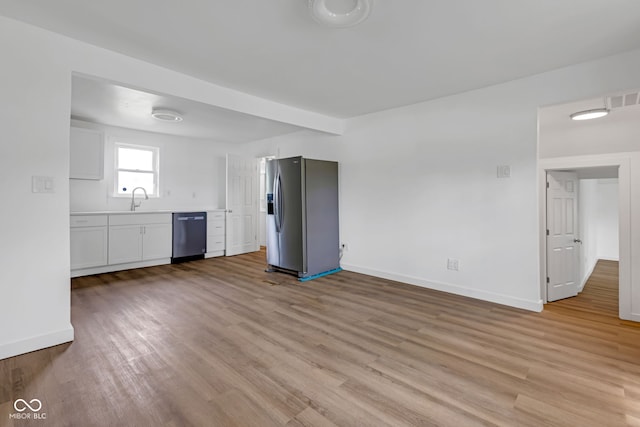 555 S Auburn St, Indianapolis, IN 46241 - unfurnished living room featuring baseboards, a sink, light wood-style flooring, and visible vents
