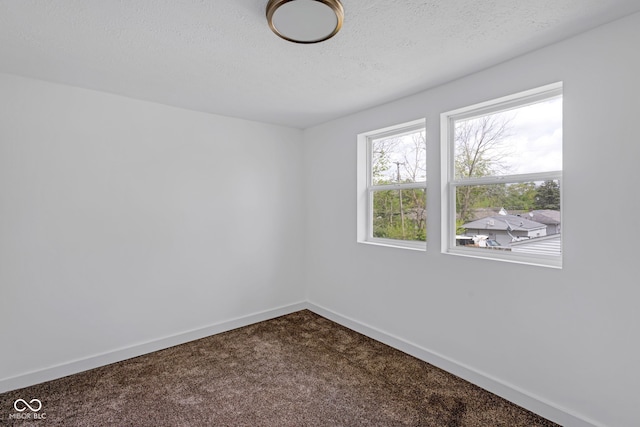 555 S Auburn St, Indianapolis, IN 46241 - unfurnished room with dark carpet, a textured ceiling, and baseboards