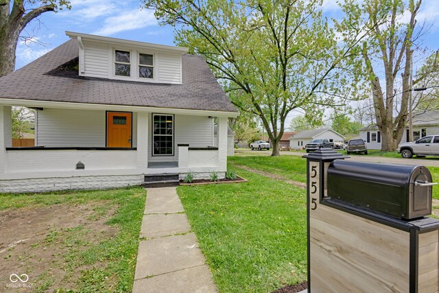 555 S Auburn St, Indianapolis, IN 46241 - bungalow featuring a shingled roof, a front lawn, and covered porch