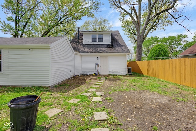 555 S Auburn St, Indianapolis, IN 46241 - rear view of property featuring central air condition unit, fence, and a shingled roof
