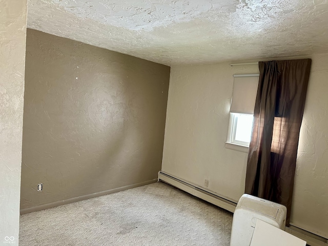 318 Elva St, Anderson, IN 46013 - empty room with baseboards, carpet flooring, a textured ceiling, and a baseboard heating unit