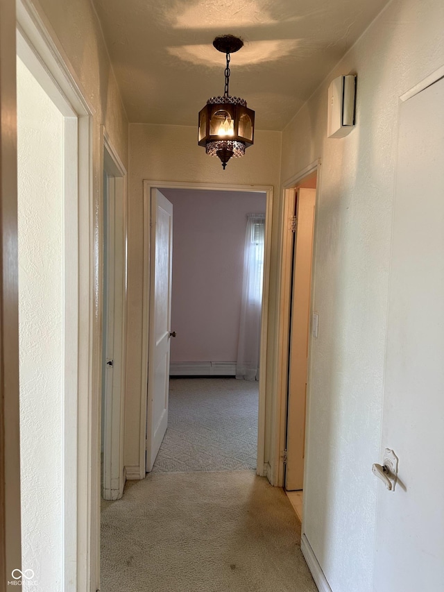 318 Elva St, Anderson, IN 46013 - corridor with baseboards, a baseboard radiator, and light colored carpet