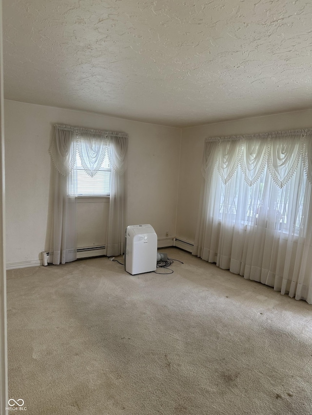 318 Elva St, Anderson, IN 46013 - spare room with carpet flooring, a textured ceiling, a baseboard heating unit, and a baseboard radiator