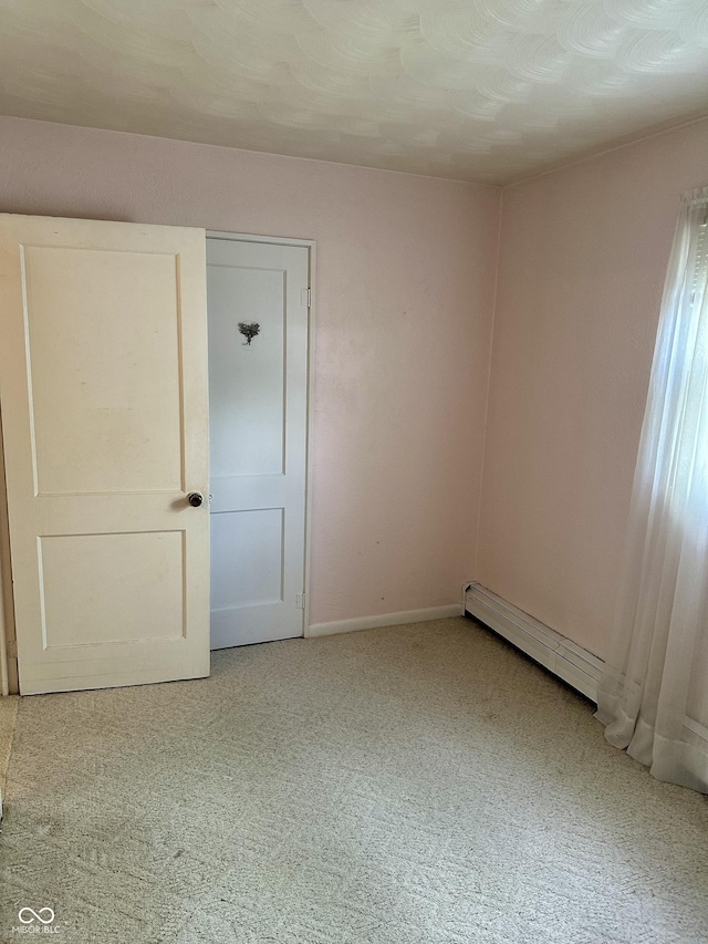 318 Elva St, Anderson, IN 46013 - carpeted empty room featuring baseboards and baseboard heating