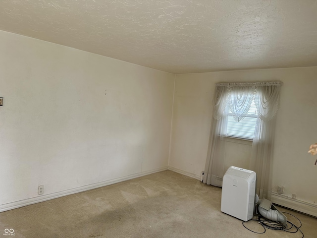 318 Elva St, Anderson, IN 46013 - empty room with a textured ceiling, light colored carpet, and baseboards