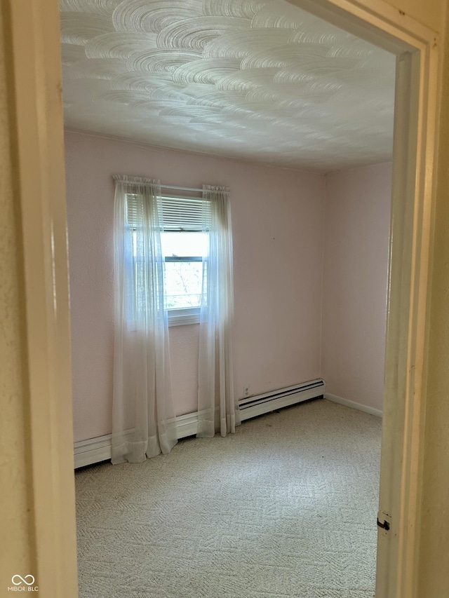 318 Elva St, Anderson, IN 46013 - unfurnished room with baseboards, baseboard heating, and carpet flooring