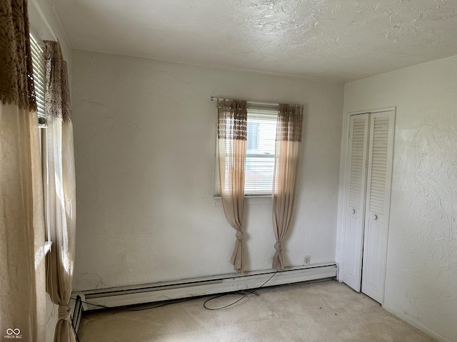 318 Elva St, Anderson, IN 46013 - unfurnished bedroom featuring carpet floors, a baseboard heating unit, and a closet