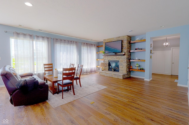 9993 Pepper Tree Ln, Noblesville, IN 46060 - living area featuring a fireplace, recessed lighting, wood finished floors, and a wealth of natural light