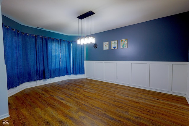 9993 Pepper Tree Ln, Noblesville, IN 46060 - spare room with visible vents, a decorative wall, wood finished floors, and a wainscoted wall