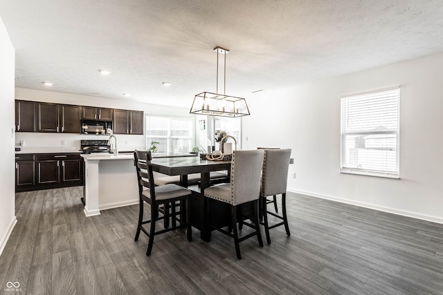 6559 Ambrosia Ln, Pendleton, IN 46064 - dining space with baseboards, a chandelier, and dark wood-type flooring