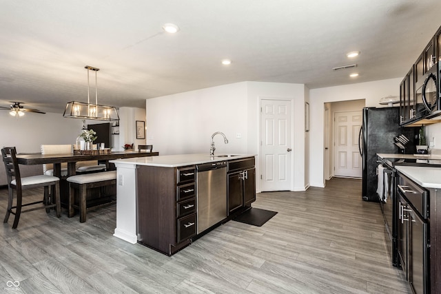 6559 Ambrosia Ln, Pendleton, IN 46064 - kitchen with visible vents, dishwasher, light countertops, a sink, and range