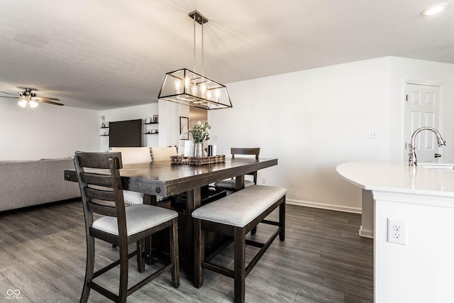 6559 Ambrosia Ln, Pendleton, IN 46064 - dining area featuring baseboards, ceiling fan with notable chandelier, and dark wood-type flooring
