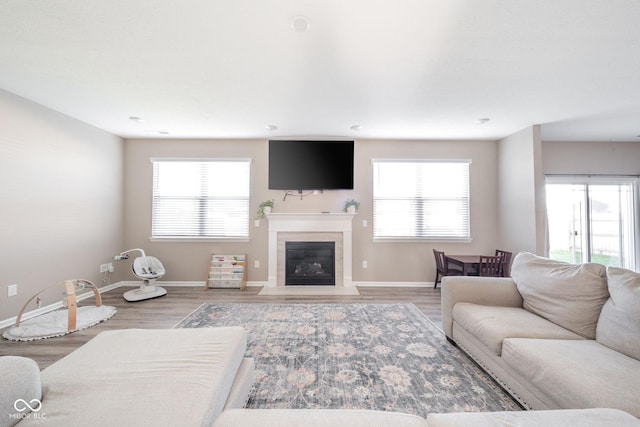 657 Kilmore Dr, Pendleton, IN 46064 - living room with baseboards, a fireplace with flush hearth, and light wood-type flooring