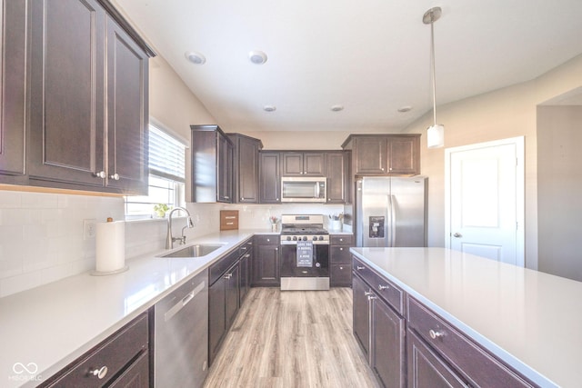 657 Kilmore Dr, Pendleton, IN 46064 - kitchen with a sink, dark brown cabinetry, light wood-style floors, light countertops, and appliances with stainless steel finishes