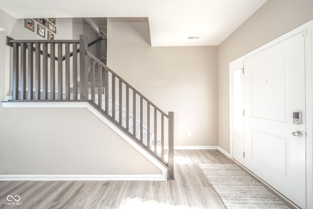 657 Kilmore Dr, Pendleton, IN 46064 - foyer featuring baseboards, stairs, visible vents, and wood finished floors