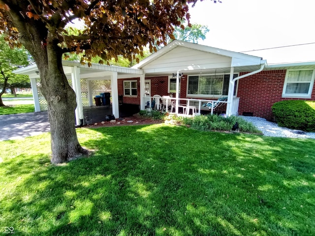 view of front of house with a porch, a front lawn, and brick siding