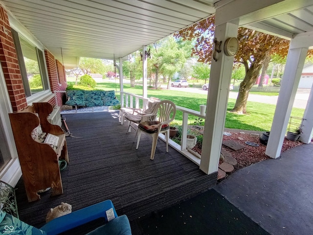 deck with a yard and a porch