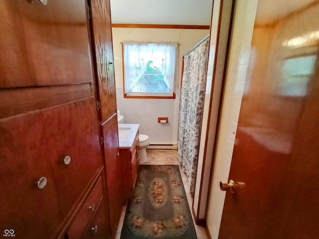 full bathroom featuring toilet, a shower with shower curtain, a baseboard heating unit, vanity, and ornamental molding